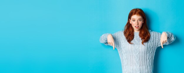 Photo portrait d'une jeune femme debout sur un fond bleu