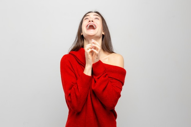 Portrait d'une jeune femme avec des émotions positives lumineuses sur un fond gris clair Photo rit filles