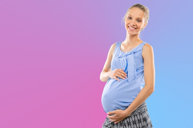 Portrait de la jeune femme enceinte souriante heureuse