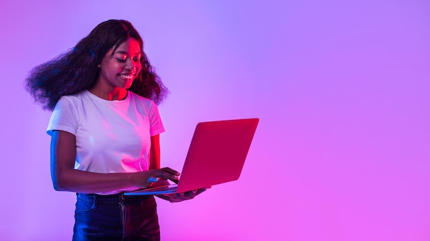 Portrait d'une jeune femme noire utilisant un ordinateur portable étudiant ou travaillant à distance lors d'une conférence en ligne