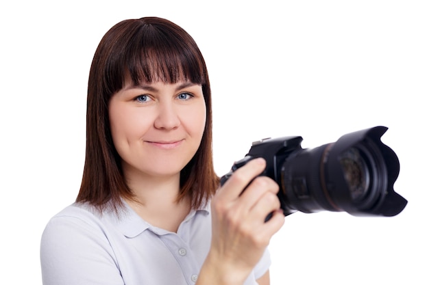 Portrait de jeune femme photographe ou vidéaste posant avec un appareil photo reflex numérique moderne isolé sur fond blanc