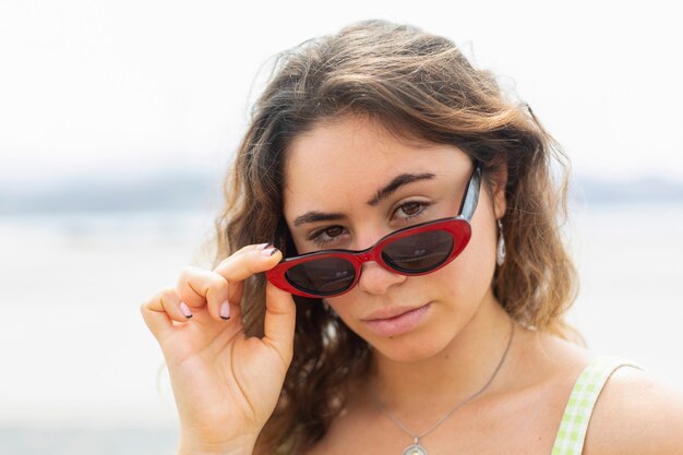 Portrait de jeune femme portant des lunettes de soleil