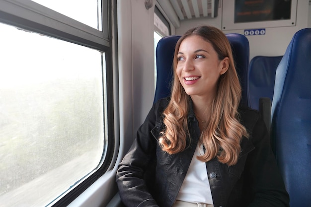 Portrait de jeune femme satisfaite voyageant avec les transports en commun assis détendu irréfléchi