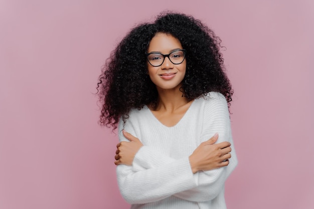 Portrait d'une jeune femme souriante sur un fond gris