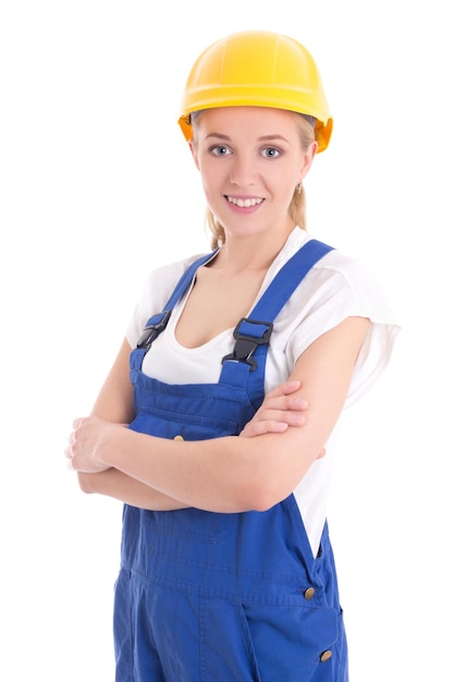 Portrait de jeune femme en uniforme de constructeur bleu isolé sur blanc