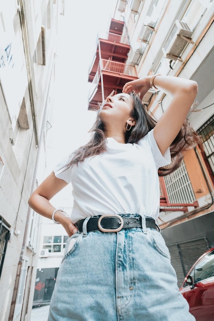 Portrait d'une jeune fille africaine arabe sur une attitude de jeune hip hop souriante semblant sérieuse à camer