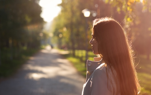 Portrait de jeune fille pensive dans le parc automne ensoleillé en octobre.