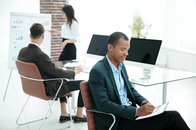 Portrait d'un jeune homme d'affaires sur fond de bureau