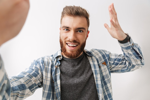 Portrait d'un jeune homme barbu heureux debout