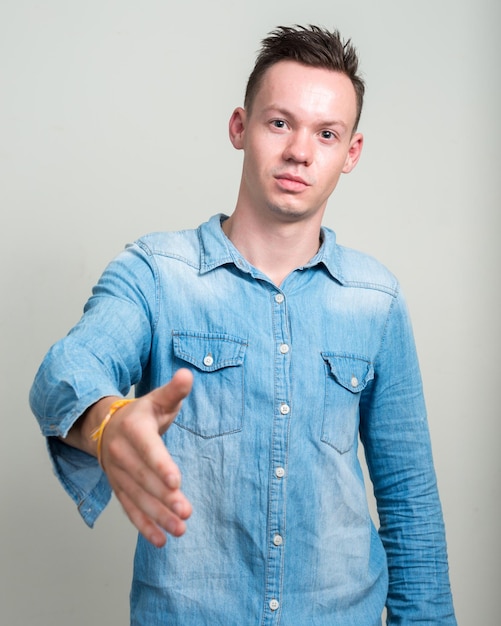 Portrait d'un jeune homme debout contre le mur