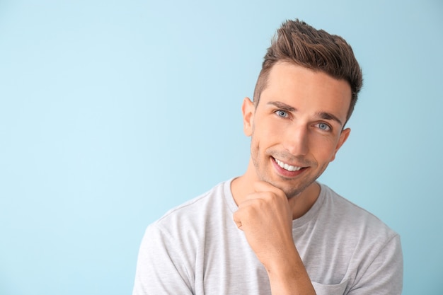 Portrait de jeune homme élégant sur bleu