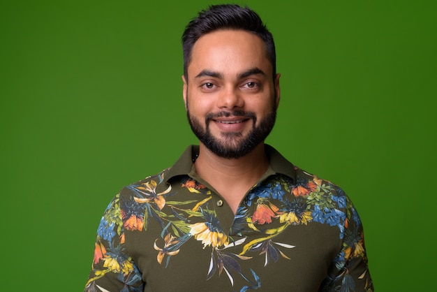 Portrait de jeune homme indien barbu sur vert