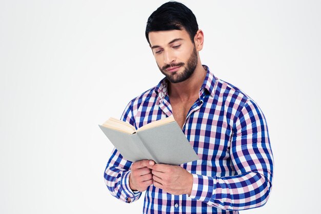 Portrait d'un jeune homme livre de lecture isolé sur un mur blanc