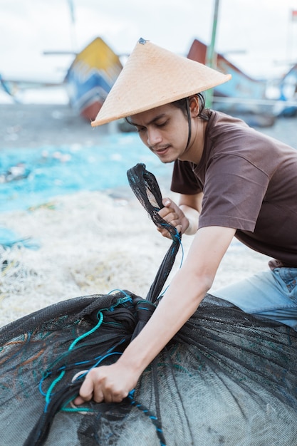 Portrait D'un Jeune Homme Pêcheur Préparant Un Filet De Pêche