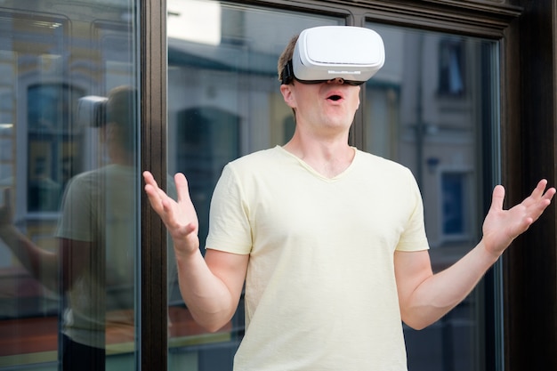 Portrait de jeune homme séduisant souriant portant des lunettes virtuelles