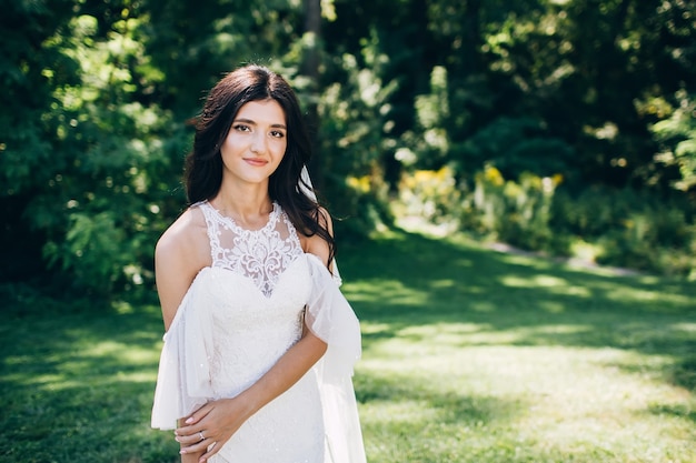 Portrait d'une jeune mariée posant dans la nature