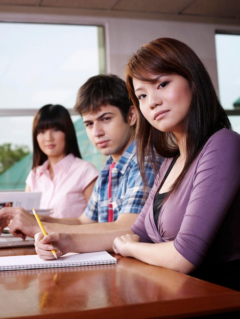 Portrait de jeunes amis assis à la bibliothèque