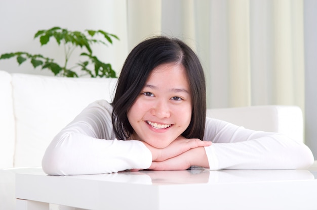 Portrait de jolie fille asiatique souriante. Jeune femme vivant à l&#39;intérieur à la maison.