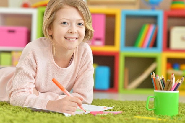 Portrait de jolie fille dessinant à la maison