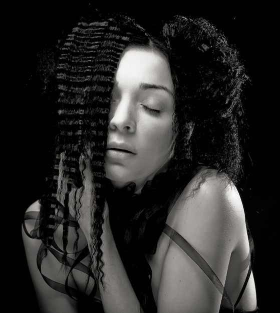 Portrait de jolie jeune femme aux cheveux bouclés