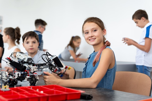 Portrait d'une jolie petite fille dans un cours de robotique à l'école