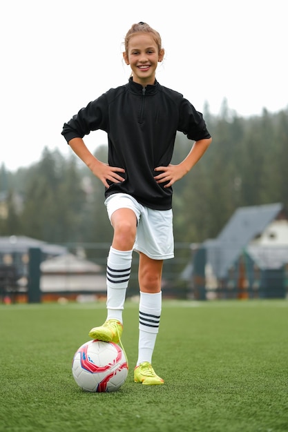 Photo portrait d'une joueuse de football heureuse sur le terrain de football