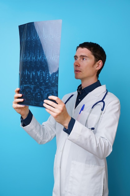 Portrait d'un médecin avec un stéthoscope sur le cou et une radiographie à la main