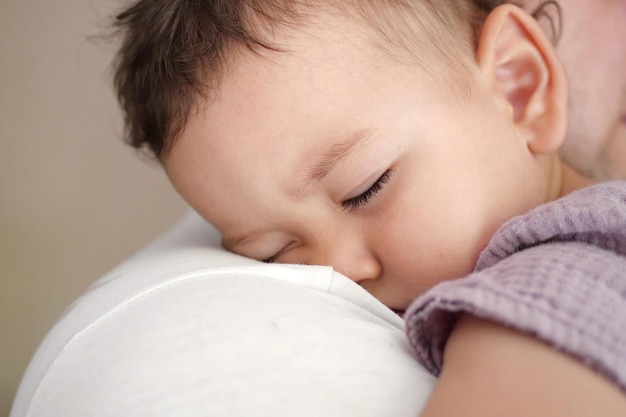 Portrait d'une mère heureuse tenant un bébé endormi