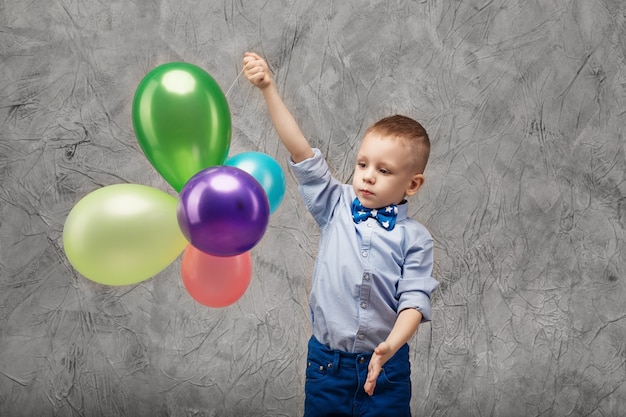 Portrait d'un mignon petit garçon avec des ballons