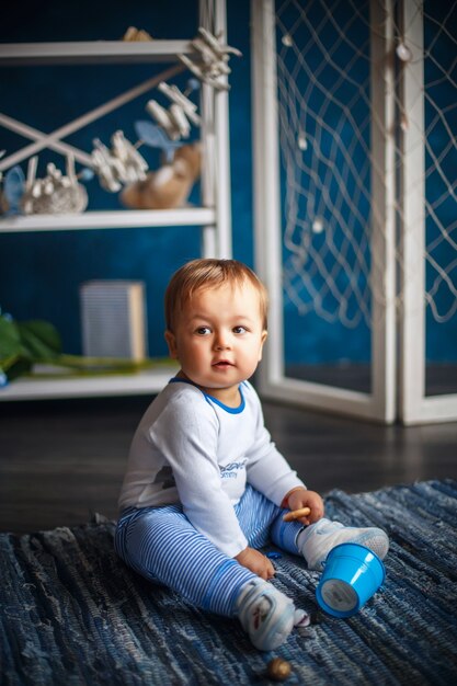 Portrait d'un mignon petit garçon à l'intérieur avec un style de mer