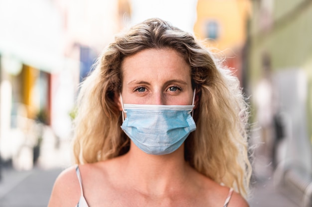 Portrait of caucasian girl wearing medical protection mask for coronavirus propagation prevention