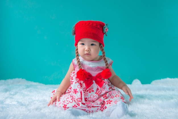 Portrait of cute asian baby in pink dress on carpet woolhappy baby conceptsmilethail little baby