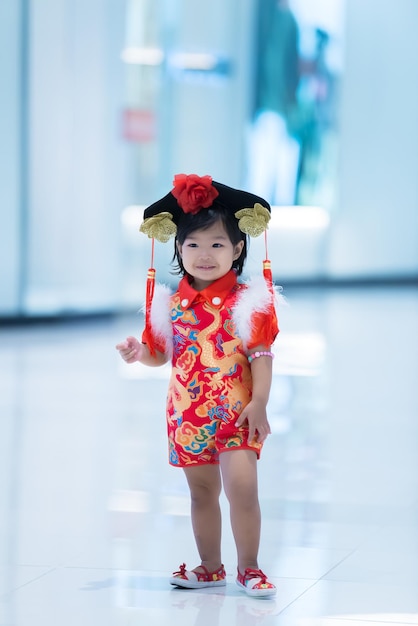 Portrait of cute little girl asian woman in Cheongsam dressThailand peopleHappy Chinese new year concept