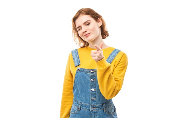 Portrait of friendly redhead girl vous choisit pointe le doigt vers l'appareil photo isolé sur fond blanc