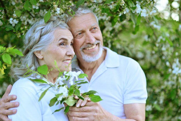 Portrait of happy couple hugging in spring park