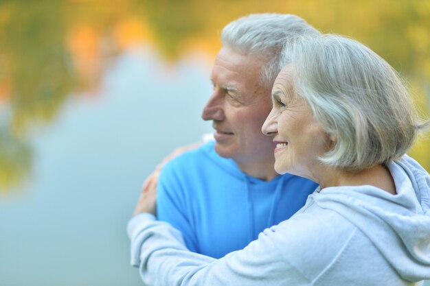 Portrait of happy senior couple in autumn park