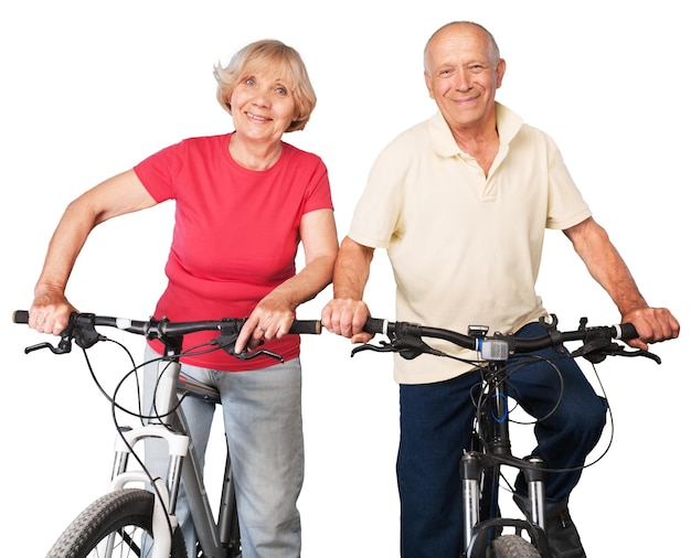 Portrait of happy senior couple riding bikes