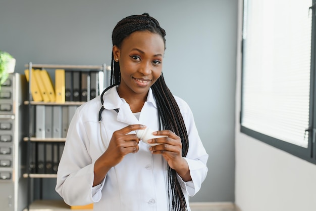 Portrait of Smiling Female Doctor Wearing White Coat With Stethoscope In Hospital Office