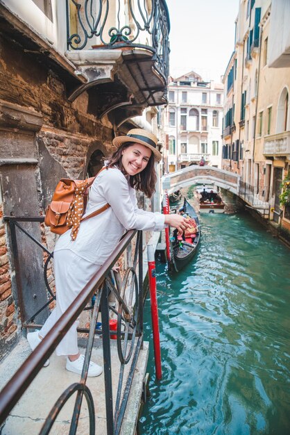 Portrait of smiling woman looking at canal avec gandola