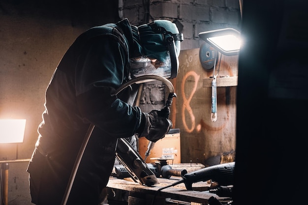 Portrait d'un ouvrier occupé sur son lieu de travail à l'usine métallurgique.