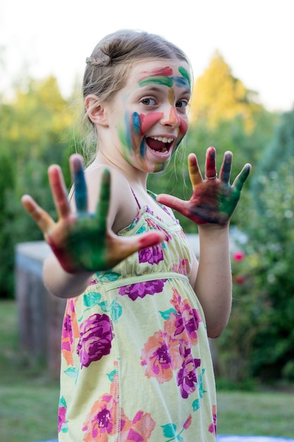 Portrait d&#39;une petite fille mignonne avec le visage et les mains peints