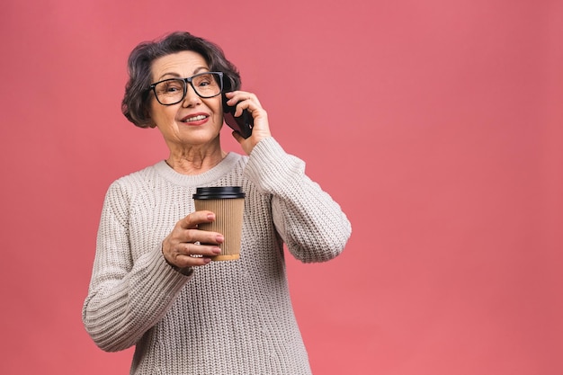 Photo portrait photo d'une femme d'âge mûr senior heureuse tenant un téléphone portable grand-mère boire du café