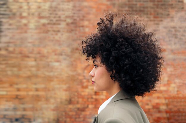 Portrait de profil d'une jeune femme aux cheveux bouclés