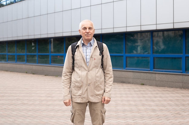 Portrait de rue d'homme mûr en tenue décontractée debout sur la rue de la ville