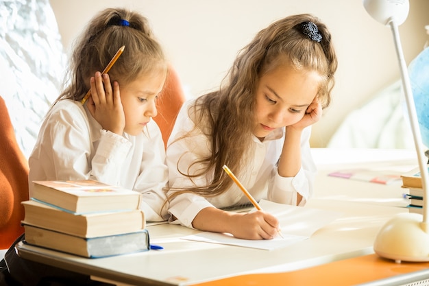 Photo portrait de sœur aînée expliquant les devoirs aux plus jeunes