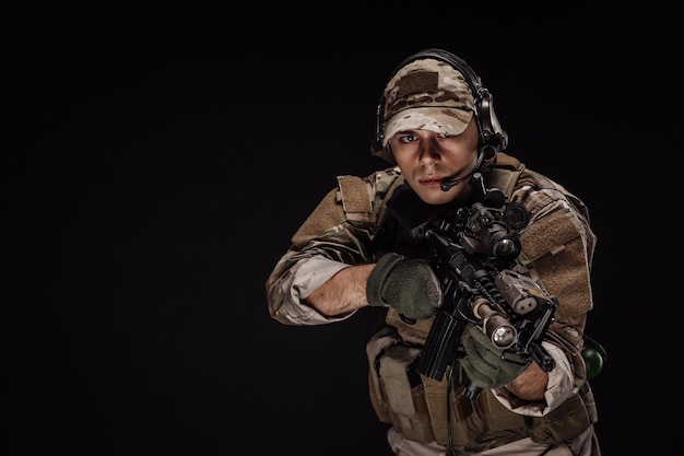 Photo portrait d'un soldat ou d'un entrepreneur militaire privé tenant un fusil de sniper technologie d'arme de l'armée de guerre et concept de personnes image sur fond noir