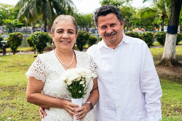 Portrait souriant de la mariée et du marié à l'extérieur