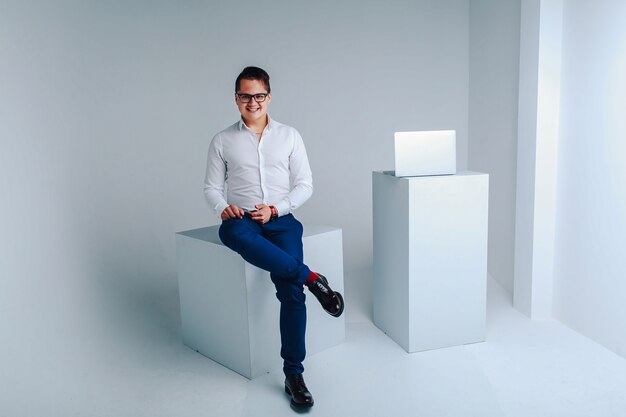 Portrait en studio de joyeux mec souriant en vêtements de cérémonie