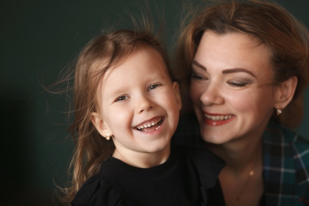 Portrait en studio d'une maman et d'une fille heureuse