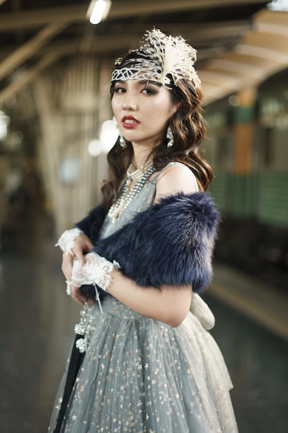 Portrait vintage rétro de la belle femme Gatsby se tenir debout, attendre le train pour l'amant, sentir l'expression face au style de mode romantique des années 20 à la gare publique, concept de mode ancienne Gatsby